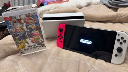 Nintendo Switch OLED with dock and smash bros game