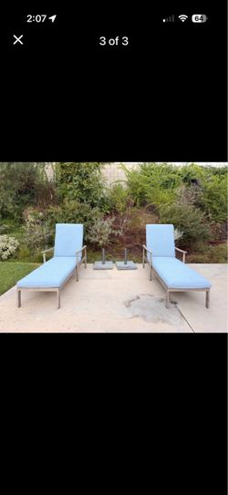 Two aluminum lounge chairs