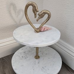 Elegant marble 2-tier serving stand with gold swan design.