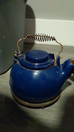 Vintage old cast iron tea kettle with trivet