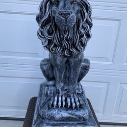 Large Lion Sitting On A Rock 