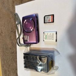 Purple Nikon Coolpix S3500 digital camera with 20.1 megapixels and 7x optical zoom. This set includes a 16GB SanDisk Ultra SD card, a Kastar rechargea
