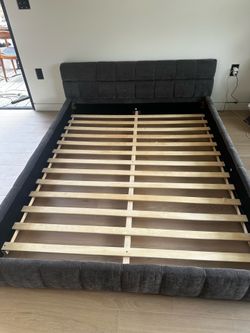 Grey upholstered queen bed fram