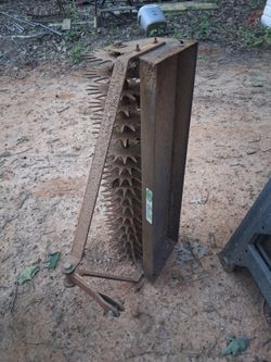 lawn aerator and 2 metal chairs