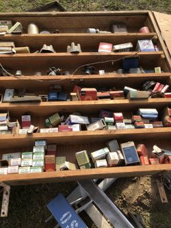 Cabinet full of antique tuneup parts brushes points condensers.