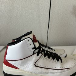 Nike Air Jordan 2 Retro "Chicago" sneakers, featuring a white leather upper with red and black accents
