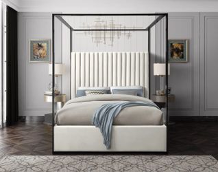 Upholstered low profile canopy bed. Cream velvet