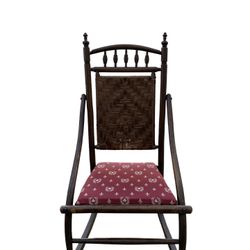 Antique Victorian spindle-back rocking chair with woven back and upholstered seat.