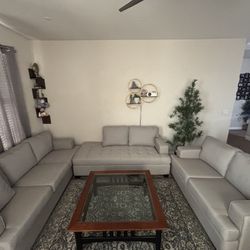 3-piece living room set that includes a large sectional couch and two stylish coffee tables.