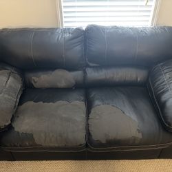 Well Loved Black Loveseat And Ottoman