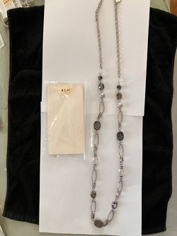 Long silver necklace with black stones