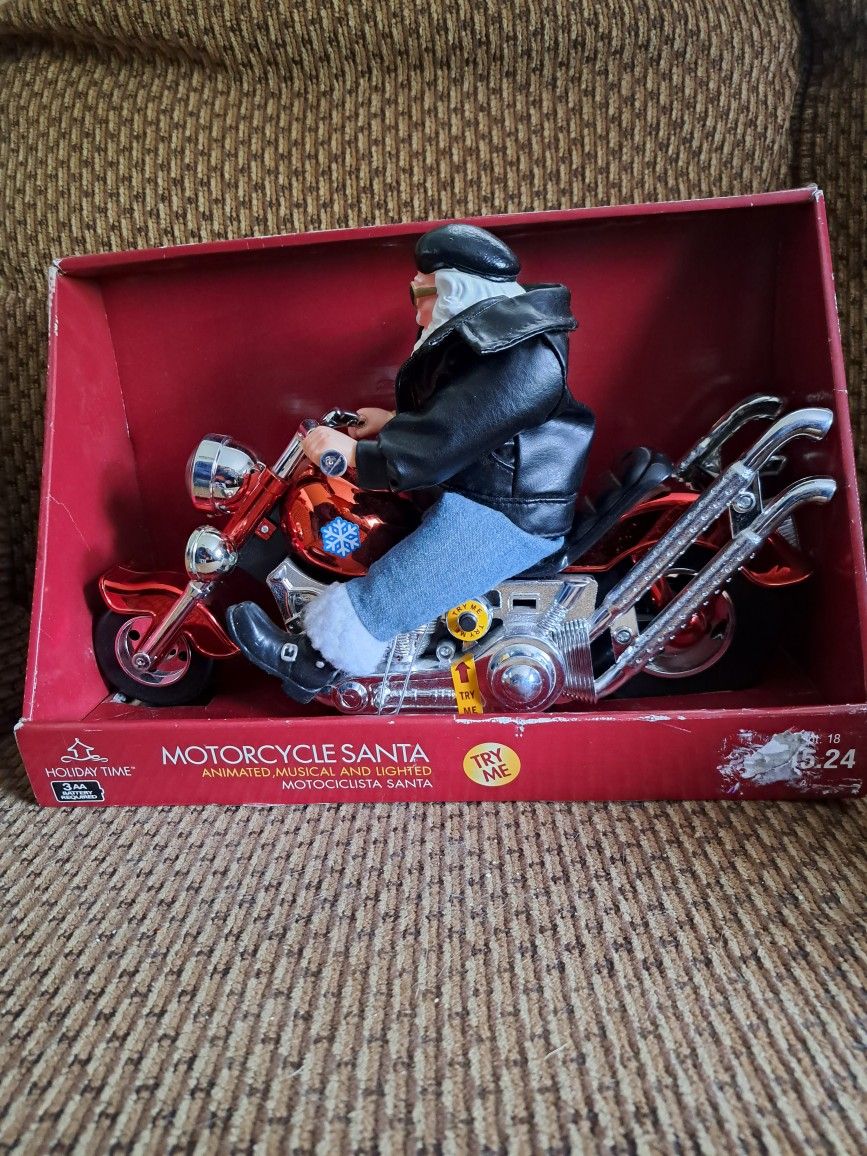 Motorcycle Santa animated musical and lights in great condition and plays born to be wild..measurements are 14" long by 9" tall