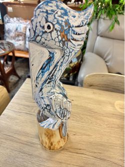 New handcrafted carved pelican on post