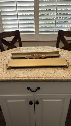 Set of two decorative gold wall shelves