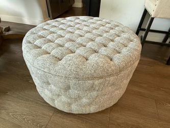 Gusseted upholstered storage ottoman