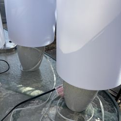 Two Gray Ceramic Lamps With White Shades