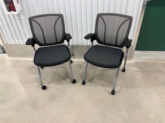 Two Global Roma Nester mesh back chair featuring a flip-up seat and silver casters.