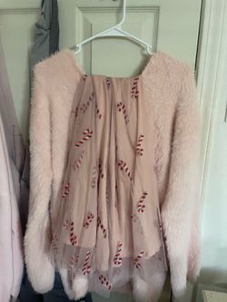 Fuzzy pink sweater with a candy cane skirt