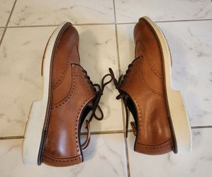 Cole Haan Go-to Wing Oxford shoes feature premium brown leather uppers and a distinctive white midsole.