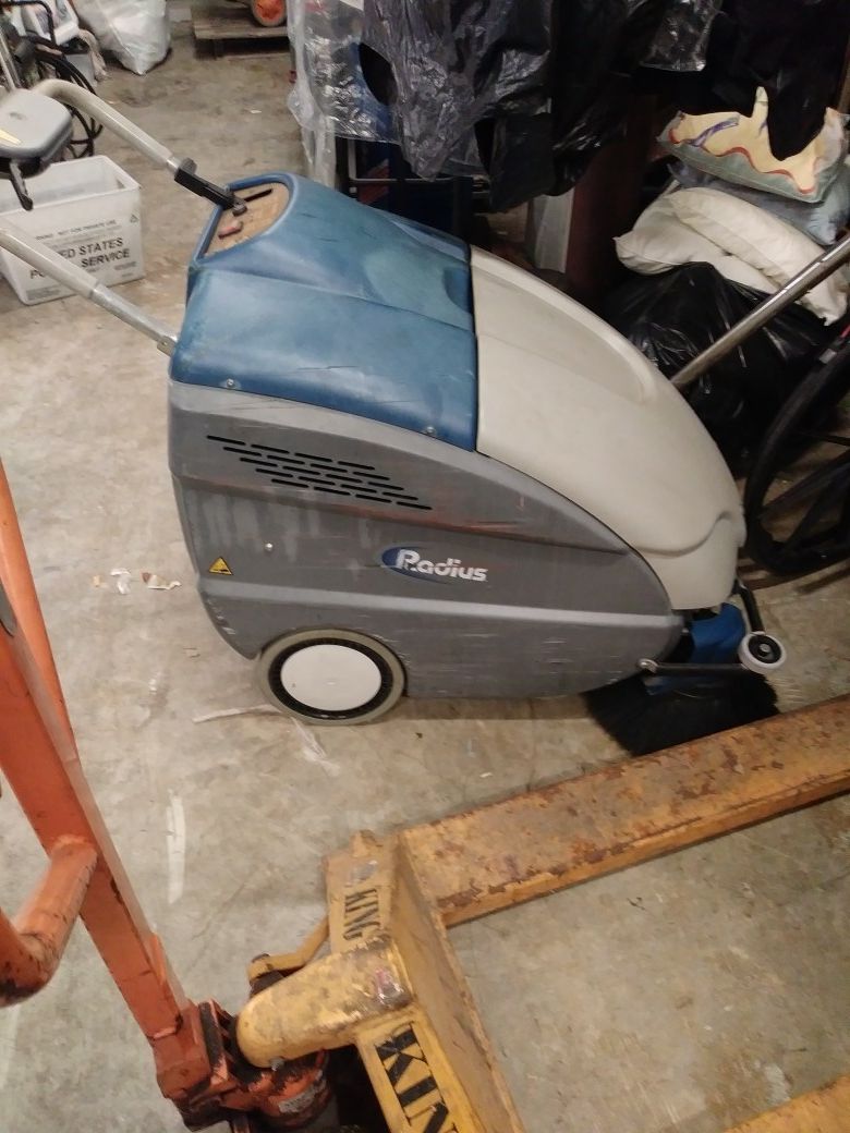 Radius walk behind industrial floor scrubber