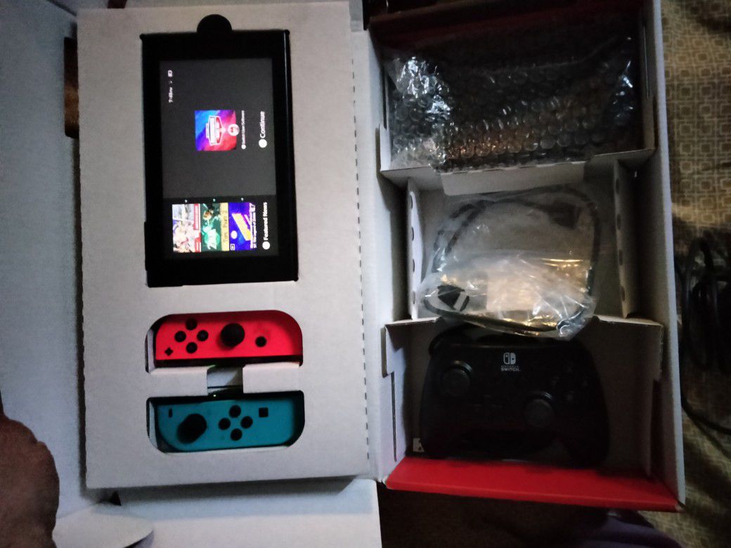Nintendo Switch With Game Consoles And An Extra Controller For The TV