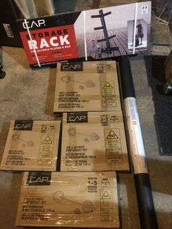 Olympic weight plates with curl barbell and rack