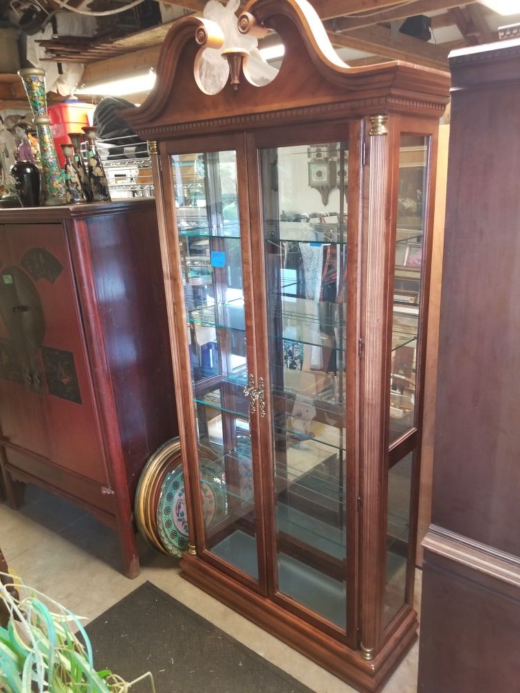 Antique Curio Cabinet with light at the top and the bottom. Mirrored back 37w x 12D x 84h 4 adjustable glass shelves with plate holder