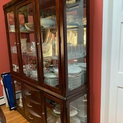 Dining room set with eight leather padded chairs and hutch