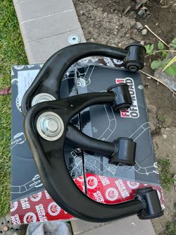 Upper control arms with spring coils