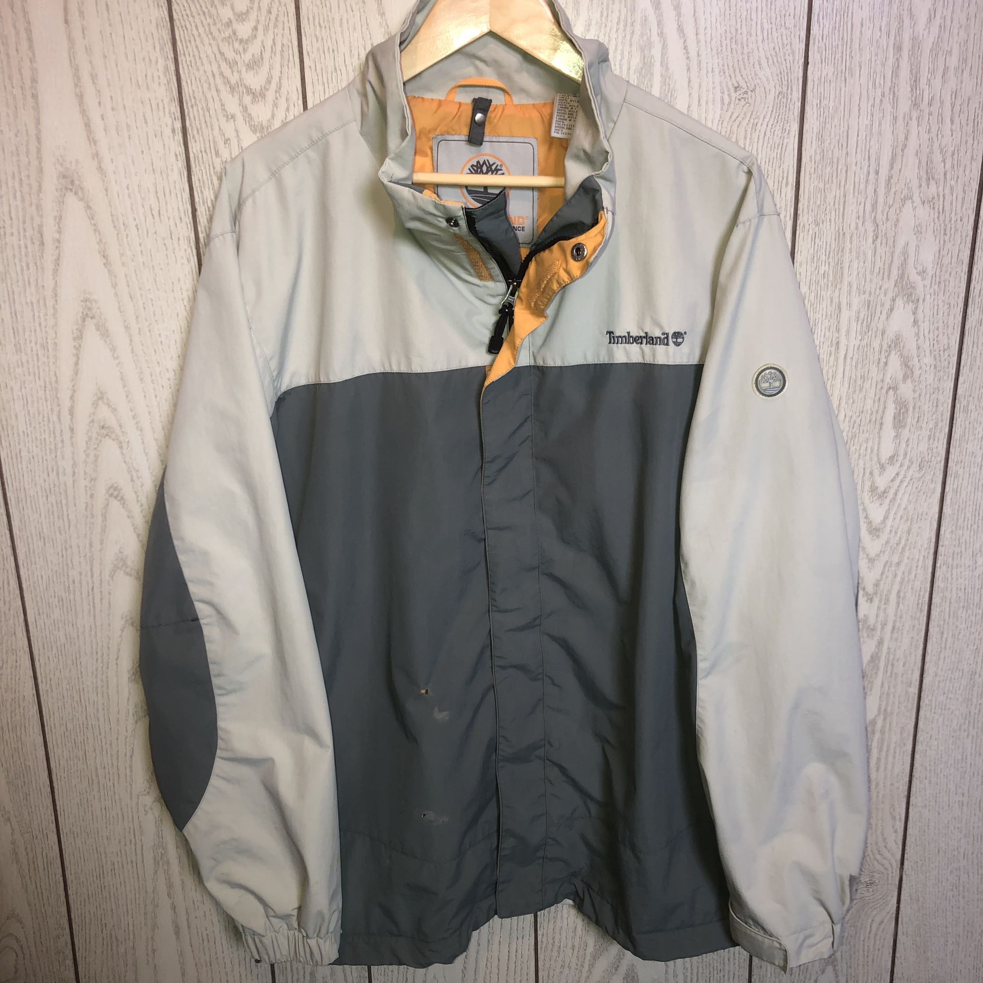 Men’s size XL Timberland Outdoor Performance Weathergear grey jacket/coat with an orange lining. It has a few spots on the back. Not sure how to rem