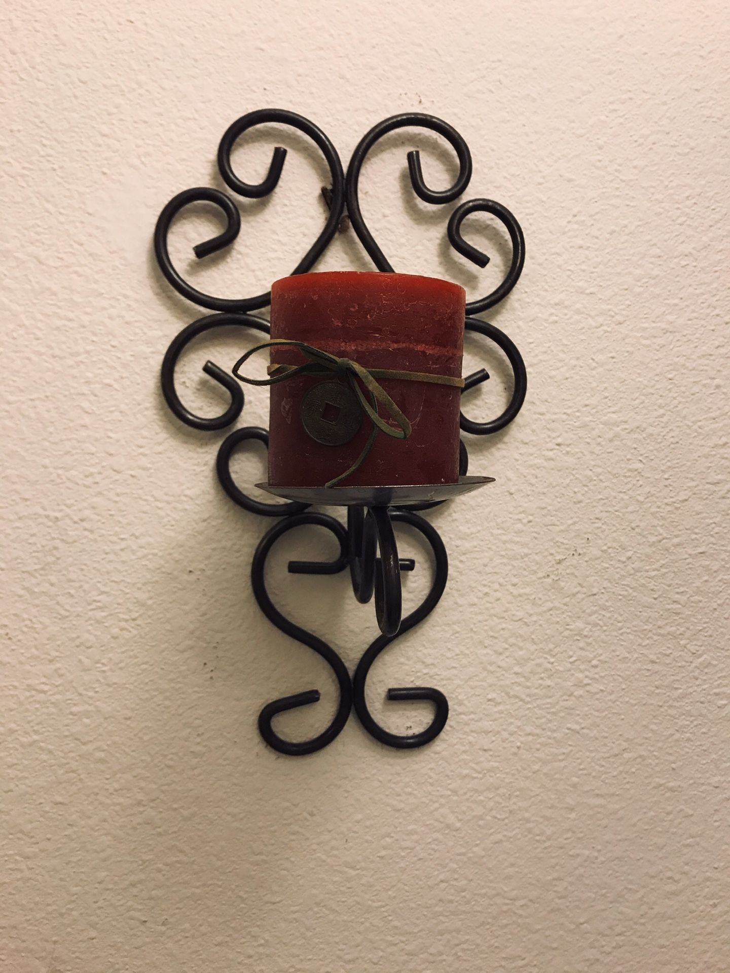 Metal wall sconce with candle