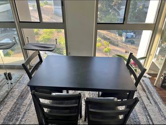 Black dining table with 4 chairs and 1 bench