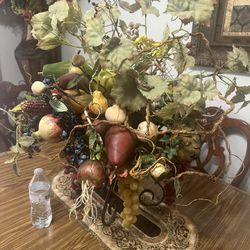 big metal vase and artificial flowers and fruit good for dining room or kitchen decor 