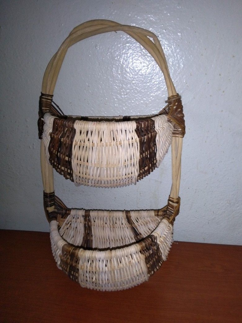 Vintage rustic, two-tiered woven basket with a branch handle