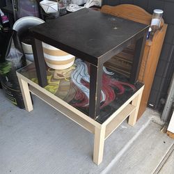 Two Ikea tables. One has glass.