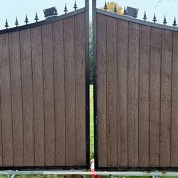 Large double-panel gate, total width about 14 ft. Two 7 ft sections, metal frame, covered with solid composite boards. Brand new, never installed. I c