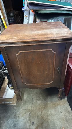 White Rotary Sewing machine in wooden cabinet.