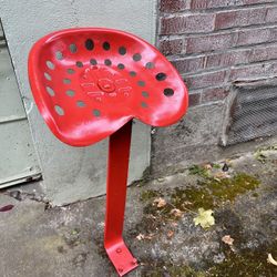 Vintage metal international tractor seat with post and bolts