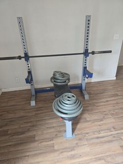 Olympic standard bench and squat rack.
Olympic bar and 255 lbs