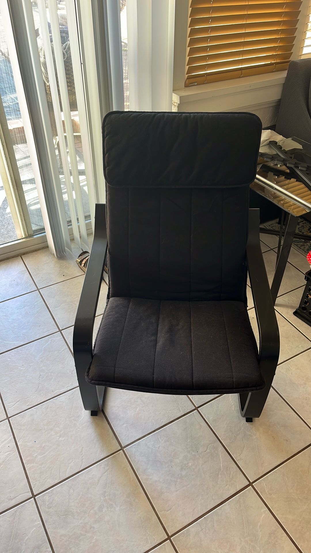 IKEA POÄNG armchair with a black cushion.