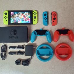 NINTENDO SWITCH with Over 130 GAMES MARIO KART , MARIO PARTY ,POKEMON ,ZELDA and Many Extras Controllers