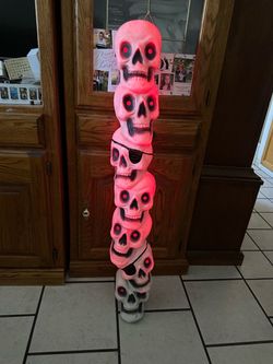 Stacked skulls with glowing red eyes