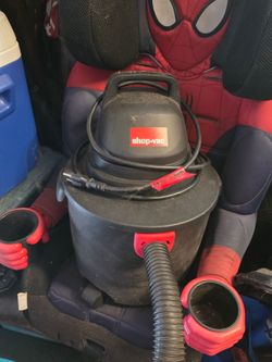 black Shop-Vac wet/dry utility vacuum with a top-mounted carrying handle and a flexible black hose connected to the front