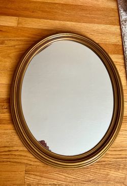 Gold oval wall mirror