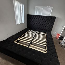 Black upholstered queen bed-frame with storage