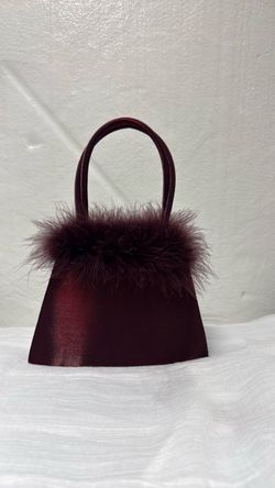 Small burgundy purse with  feather trim