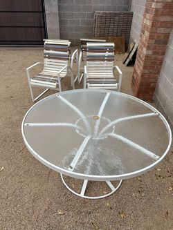 Metal and glass top patio table and chairs