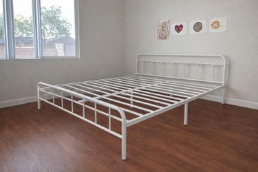 King size white metal bed frame for sale. Frame only. Mattress not included.