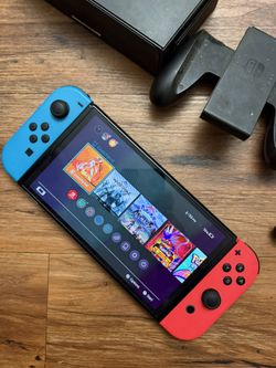 Nintendo Switch With Charger And A Couple More Things