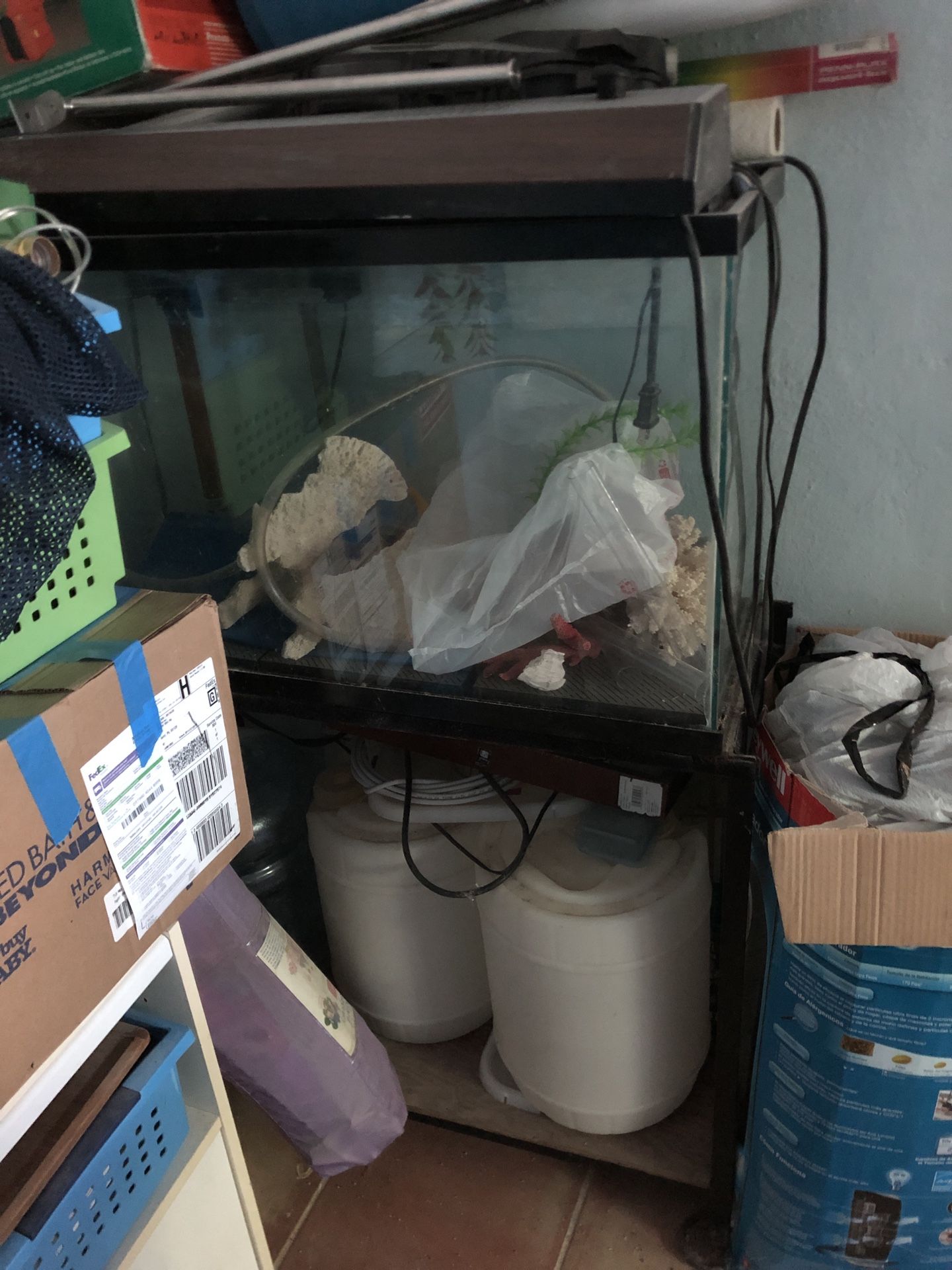 Fish tank and stand. Comes with stuff like corals and large containers for water. Also a light. It is about 18” by 29” by 12” so about 30 gallons.